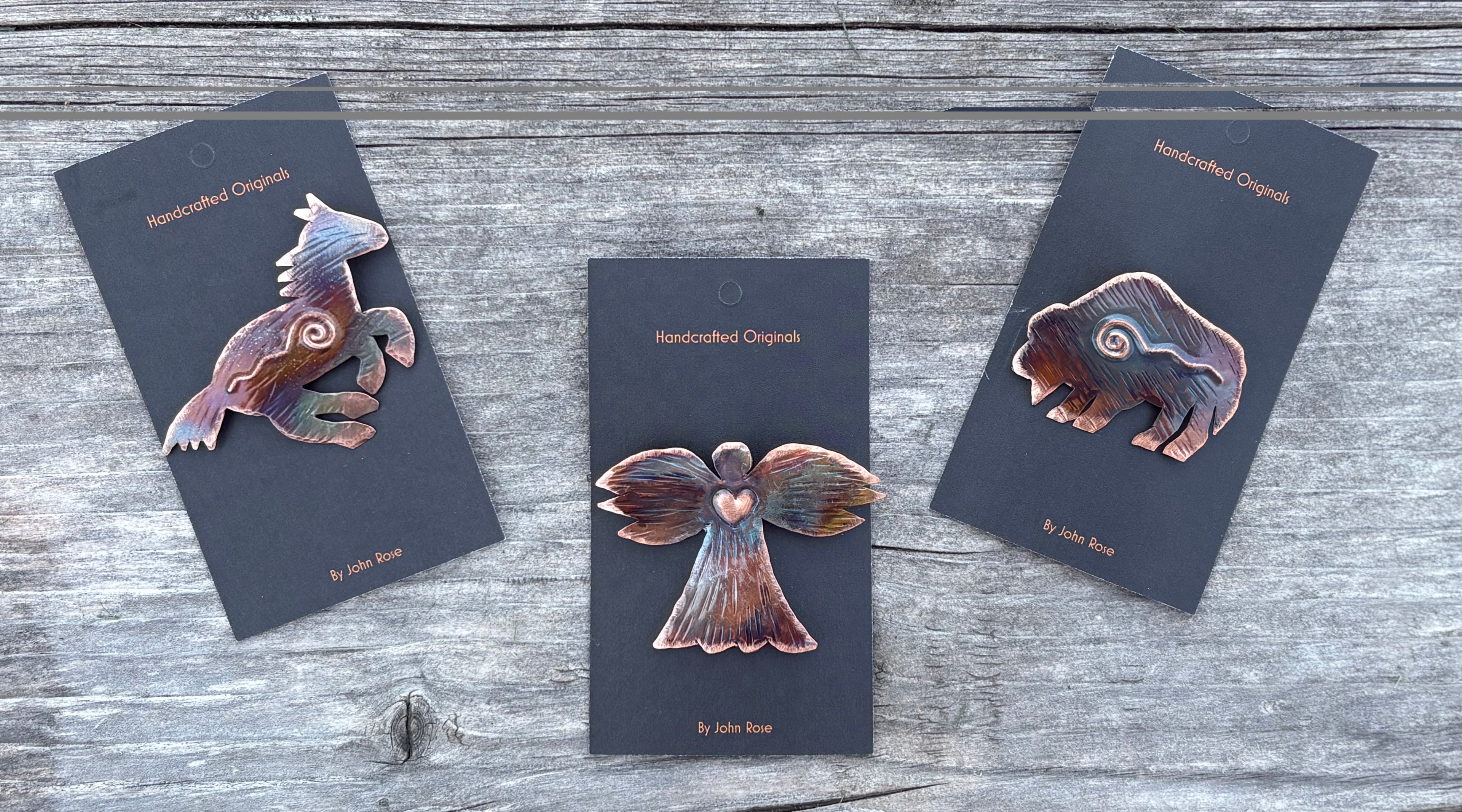 Three animal-themed brooches on cards with 'Handcrafted Originals' branding on a wooden surface.