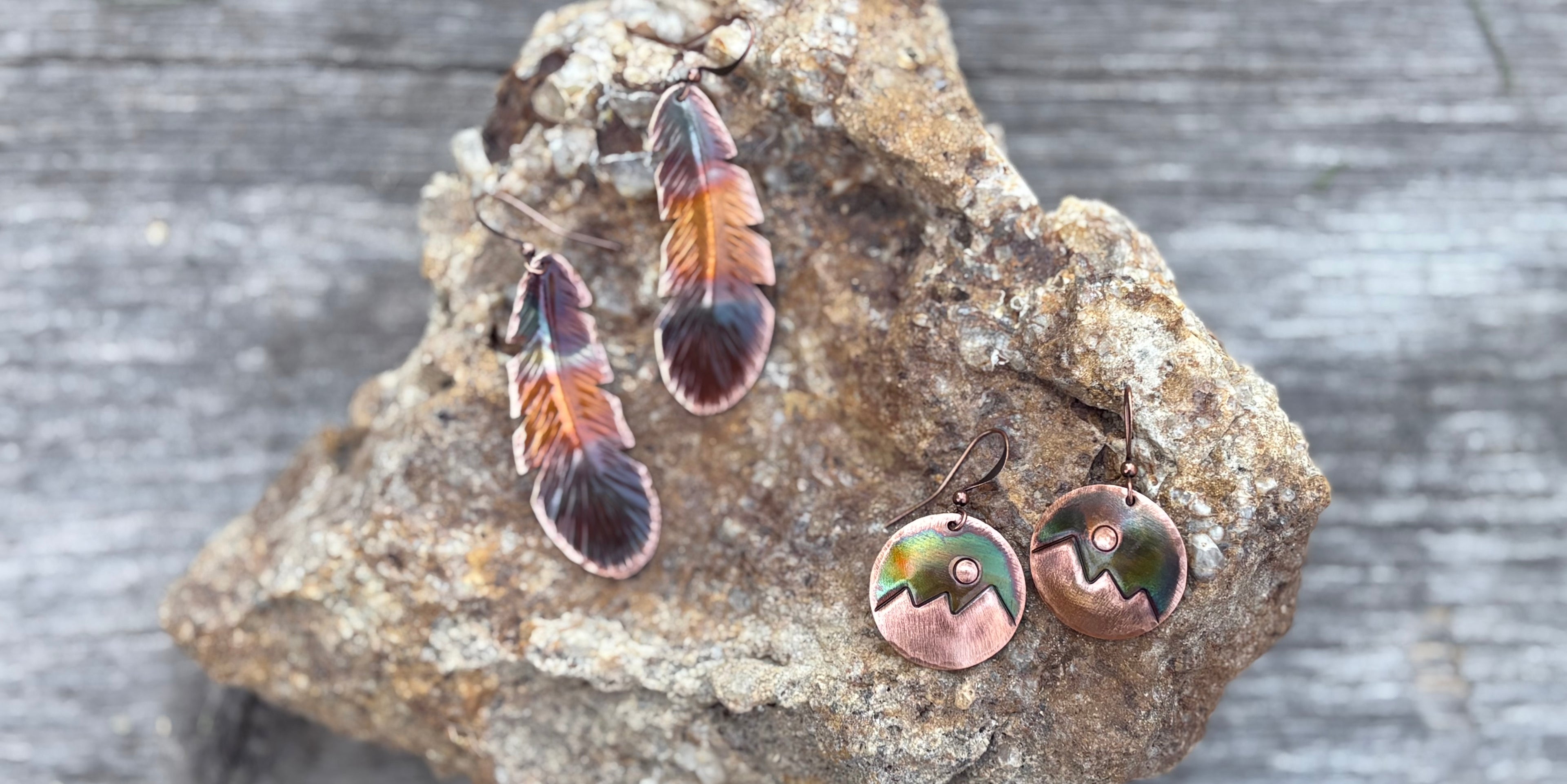 Copper earrings on a rock with a natural background
