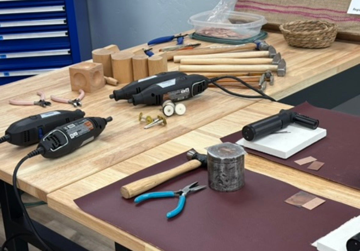 Workbench with tools including hammers, drills, and pliers in a workshop setting.