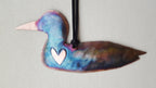 Colorful duck-shaped ornament with a heart on a light gray background