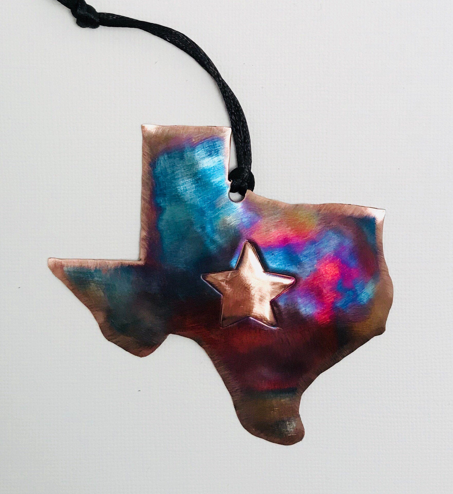 Copper Texas-shaped pendant with a star on a white background